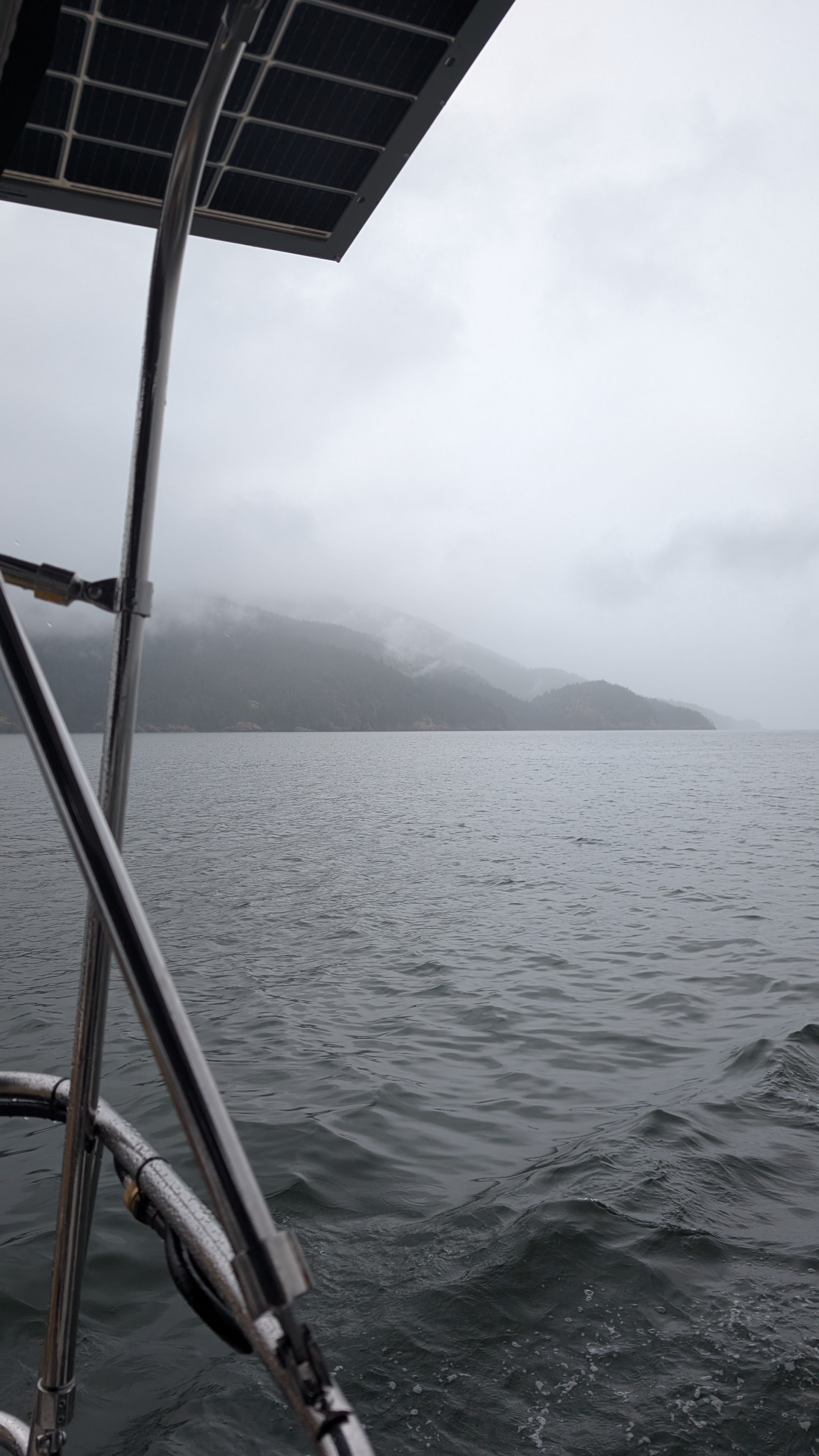Overcast view of foggy mountains from the sailboat on the passage to Sucia Island