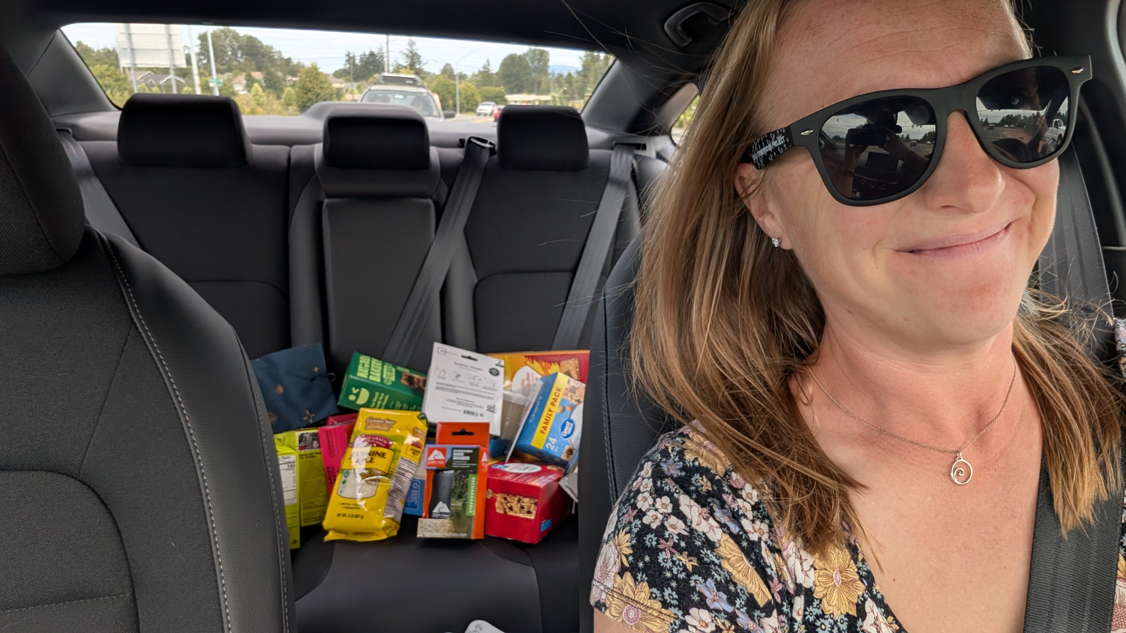 Rachel running errands in the rental car with groceries and supplies in the back seat