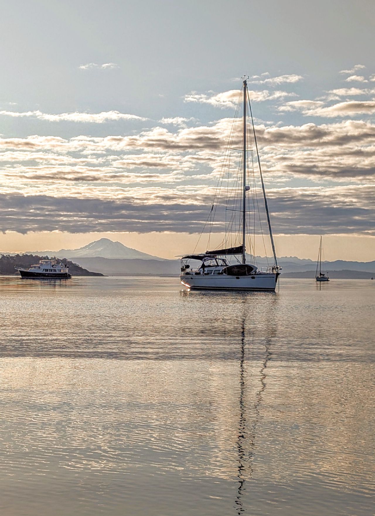 Stunning sunrise over SV Yahara at anchor near Sucia Island with Mount Baker in the background