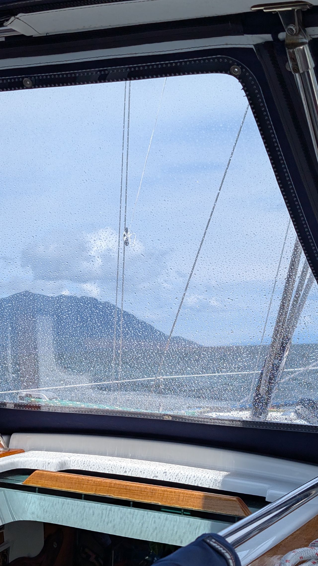 View through rain-splattered dodger window while crossing the Strait of Georgia