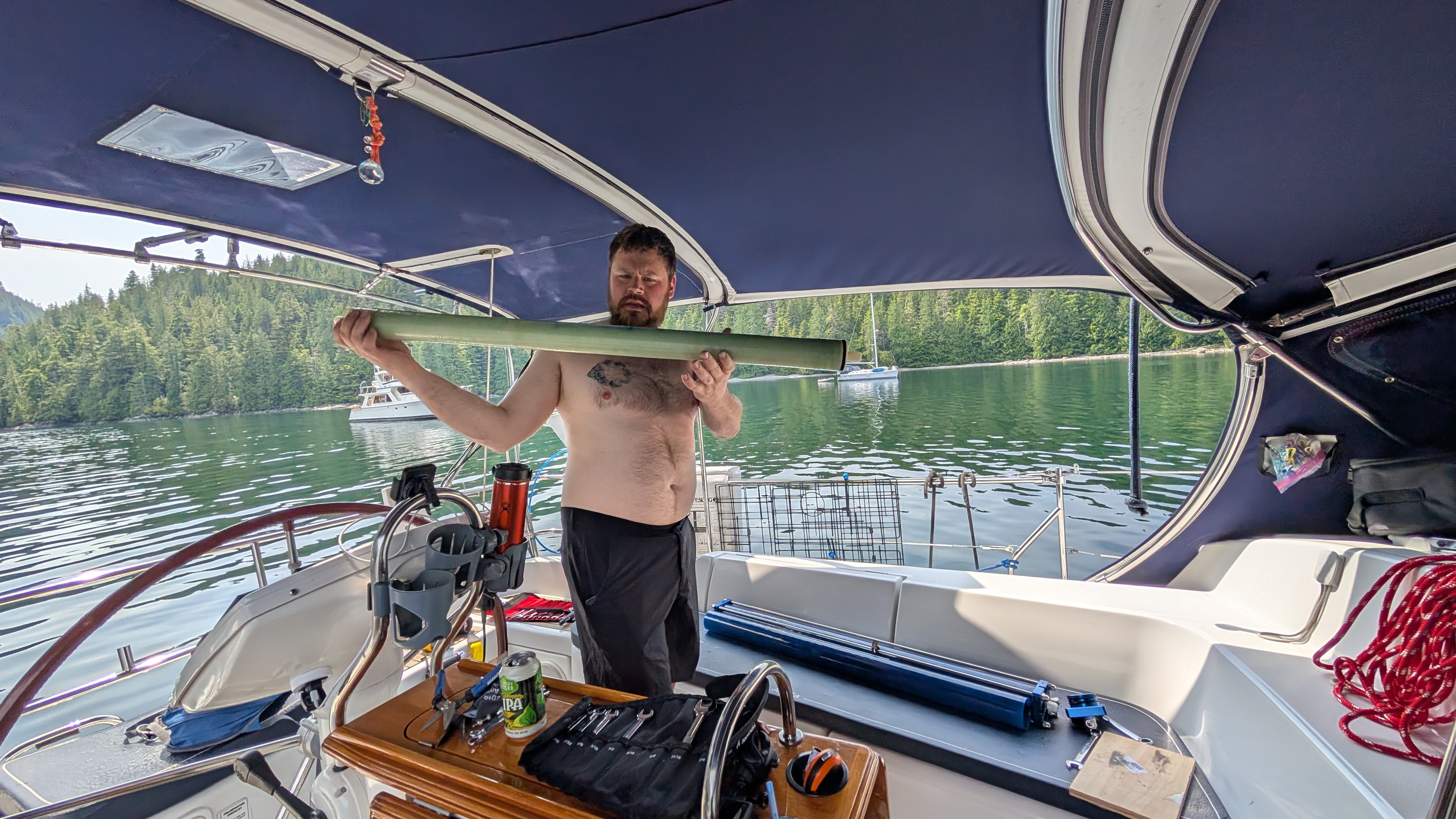 Brian holding the new watermaker reverse osmosis membrane in the cockpit of SV Yahara