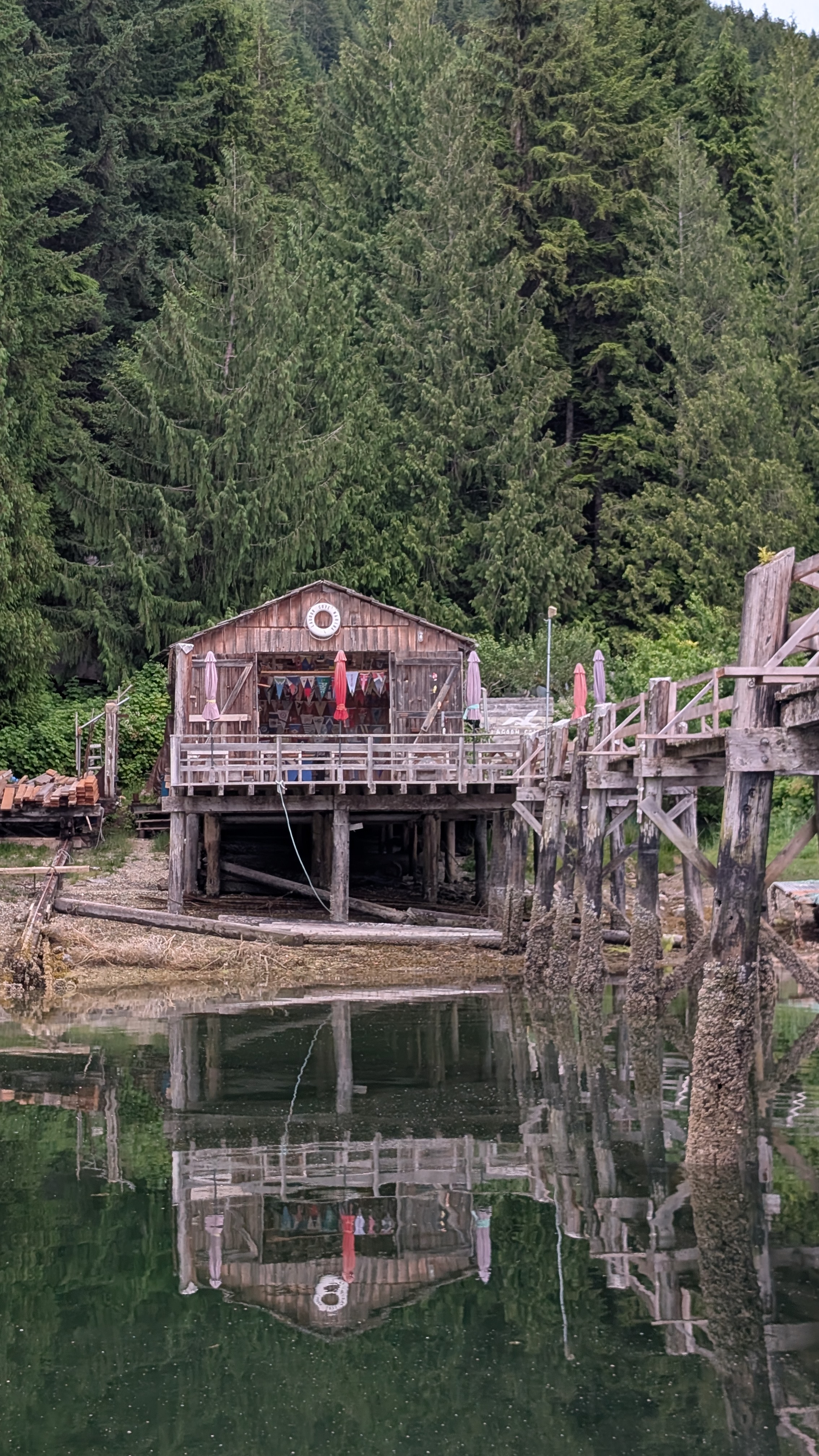 Lagoon Cove Marina building with laundry on the porch reflected in calm green water
