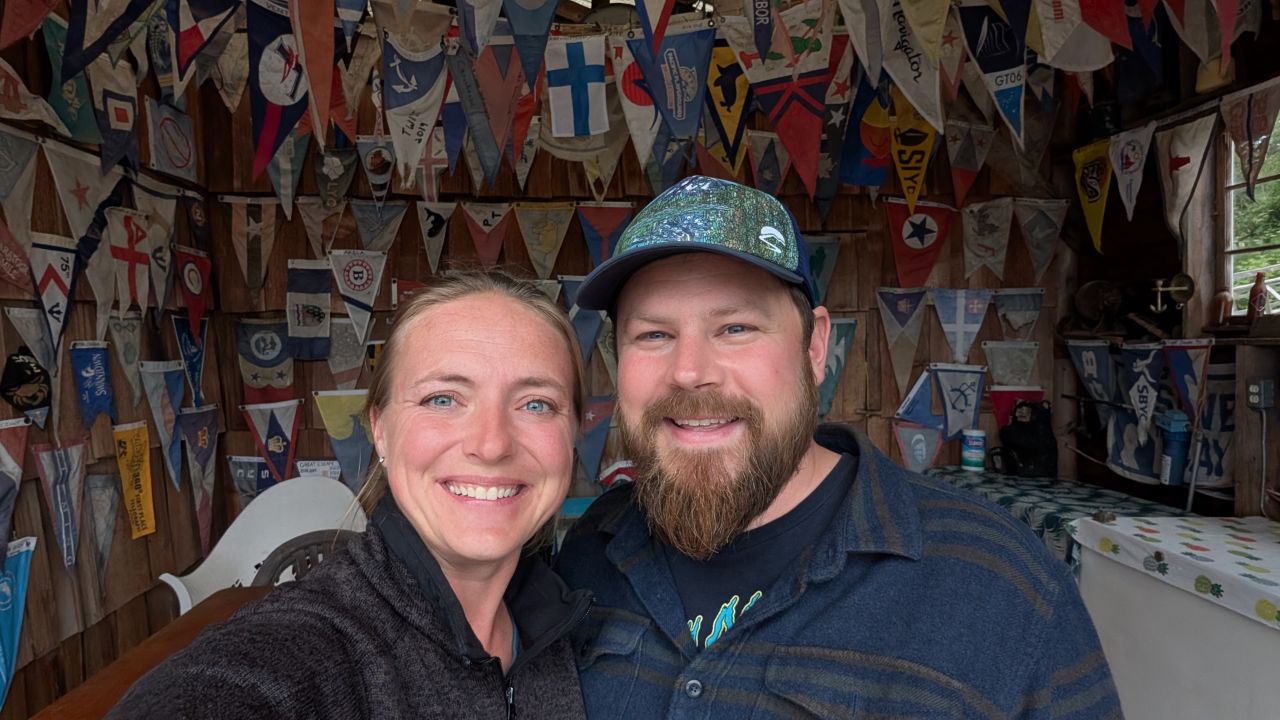 Rachel and Brian selfie surrounded by boat burgee pennants at Lagoon Cove Marina