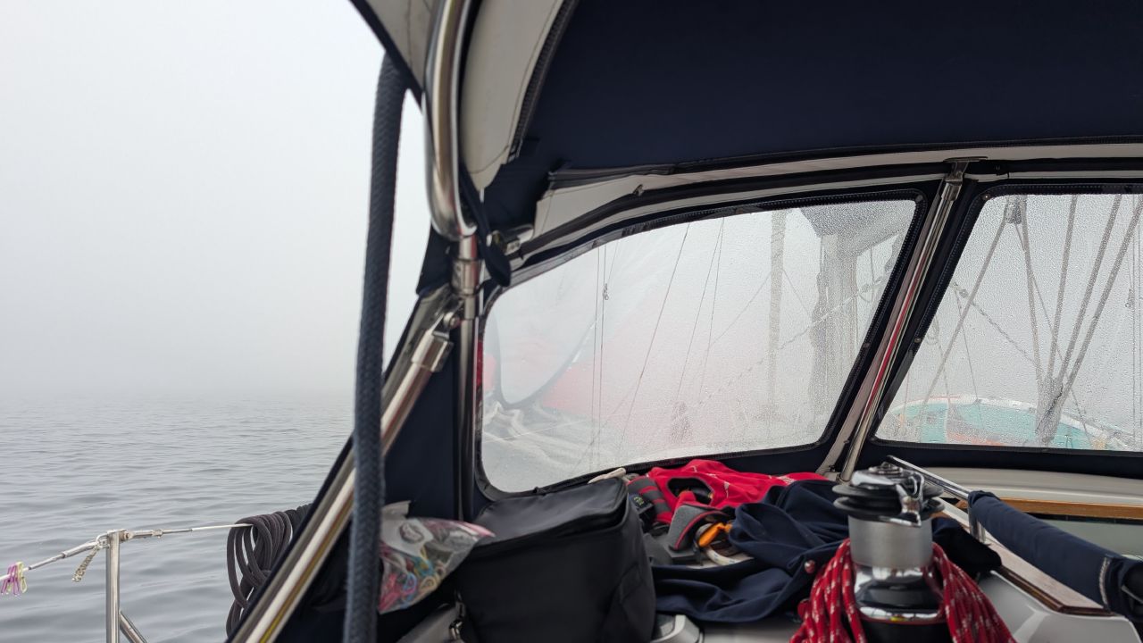 Foggy view from the cockpit through dew-covered dodger windows during the Cape Caution crossing