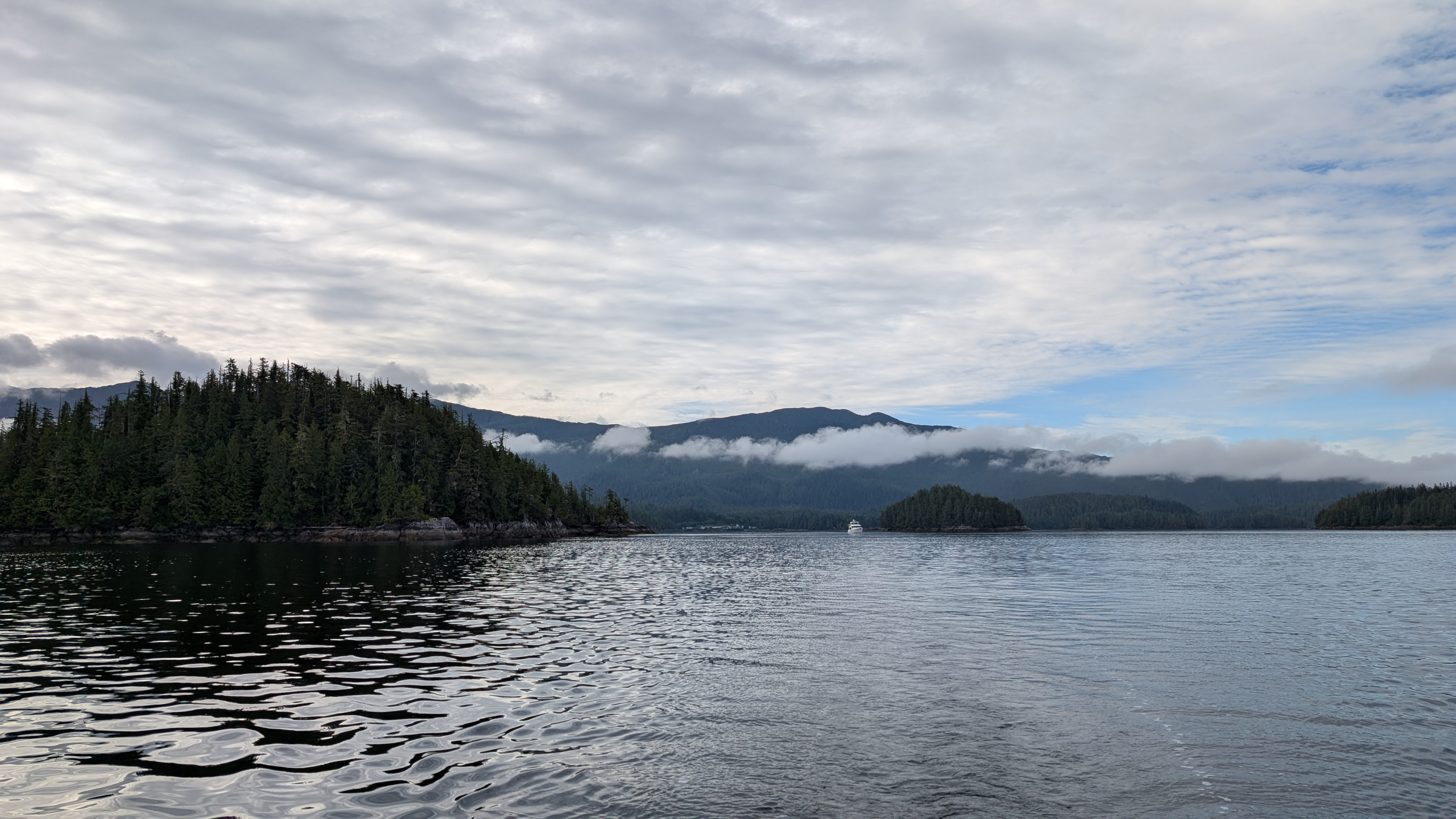 Forested islands with low hanging clouds during the passage to Codville Lagoon