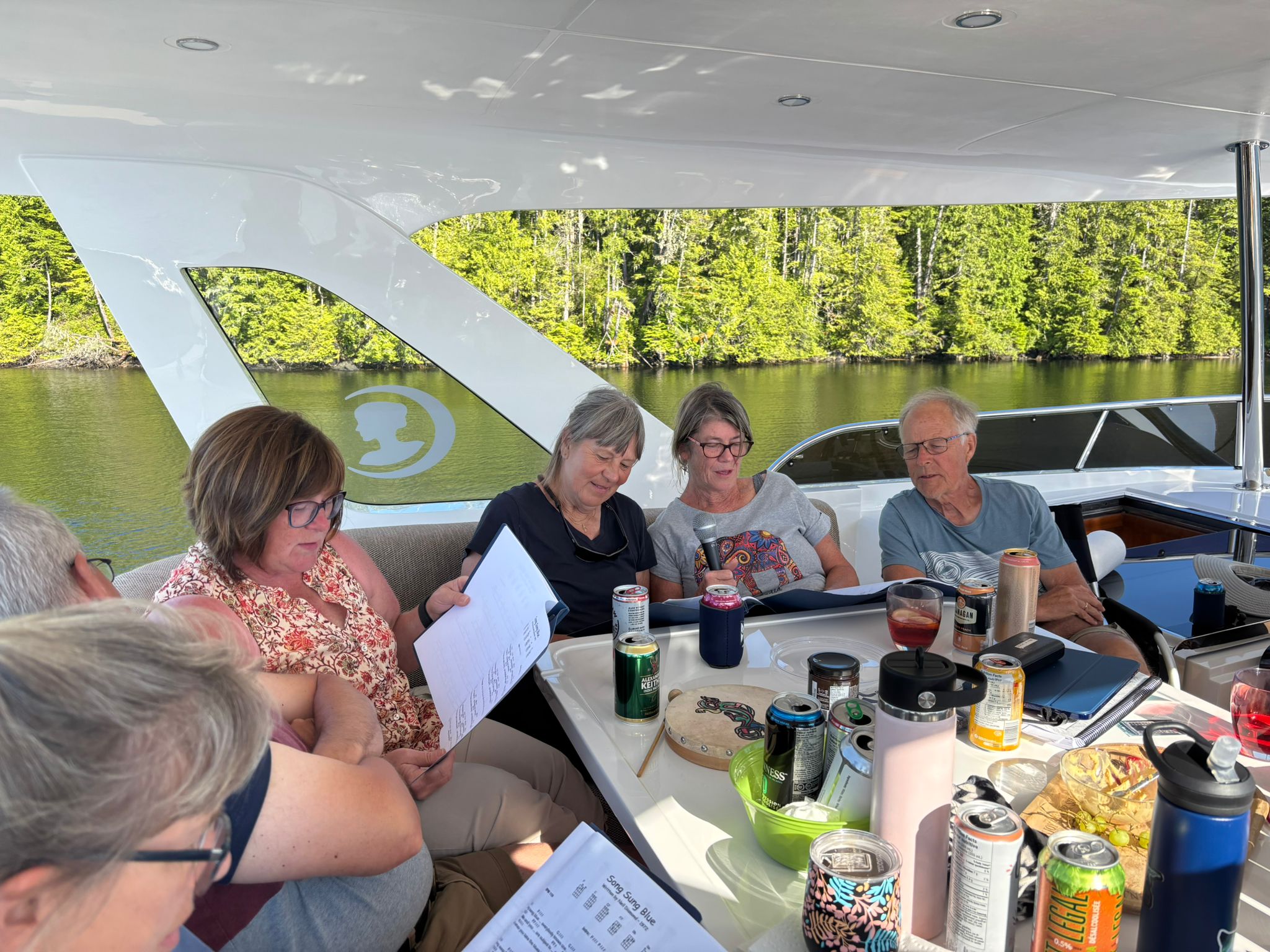 Flotilla friends gathered in the cockpit of Grato for appy hour and singing in Oliver Cove