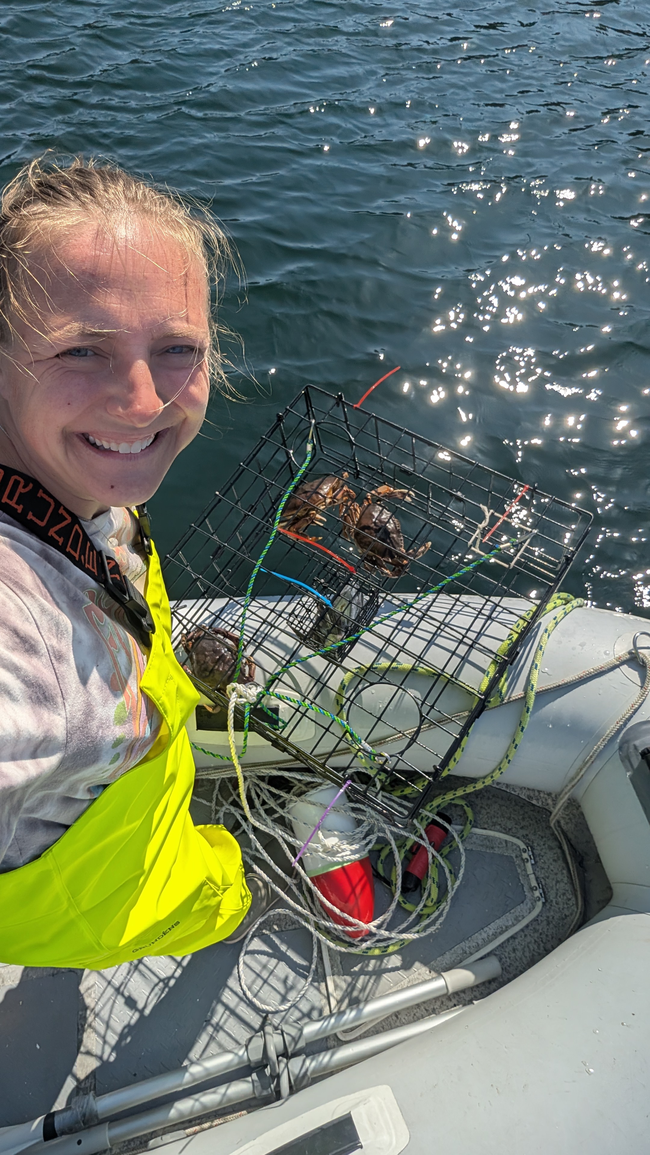 Rachel taking a selfie with a crab trap full of crabs at Barnard Harbour