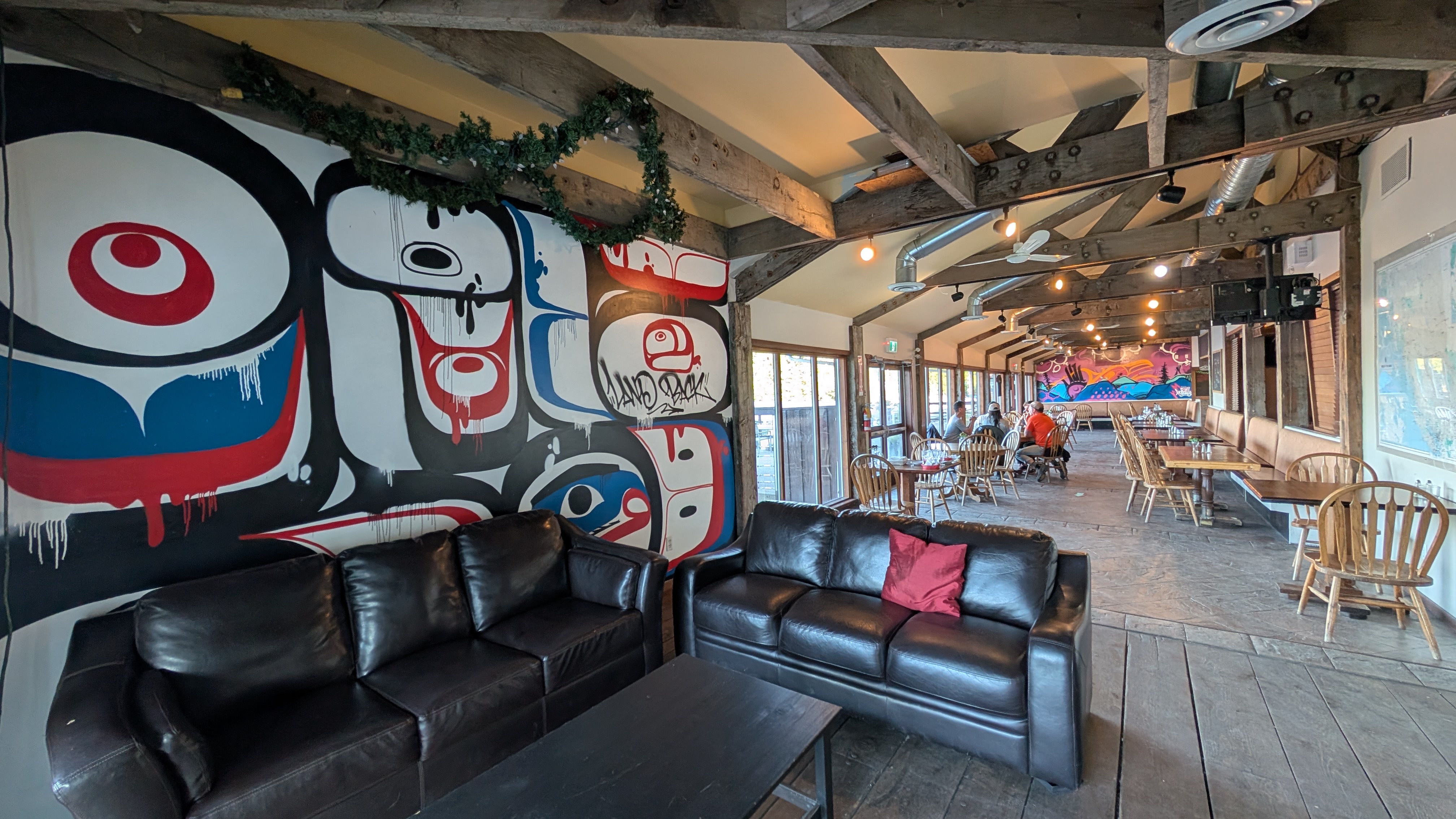 Interior of the Fisherman’s Bar and Grill at Shearwater with large First Nations mural on the wall