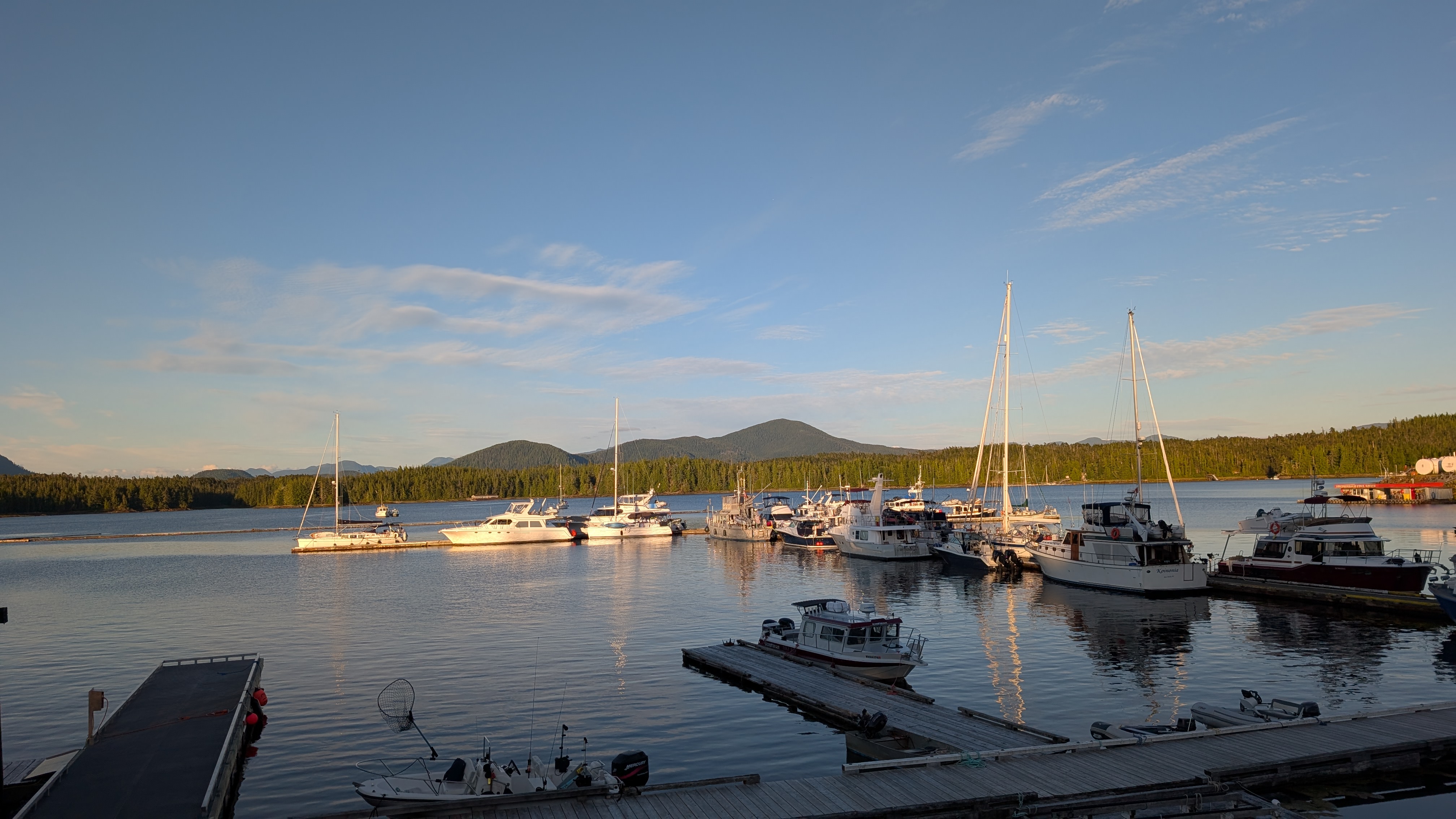 Boats docked at Shearwater Marina during golden hour with mountains in the background