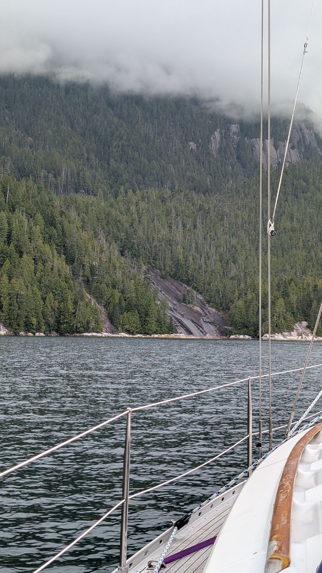 View from SV Yahara of the dried-up Lacy Falls rock face with low clouds on the mountainside