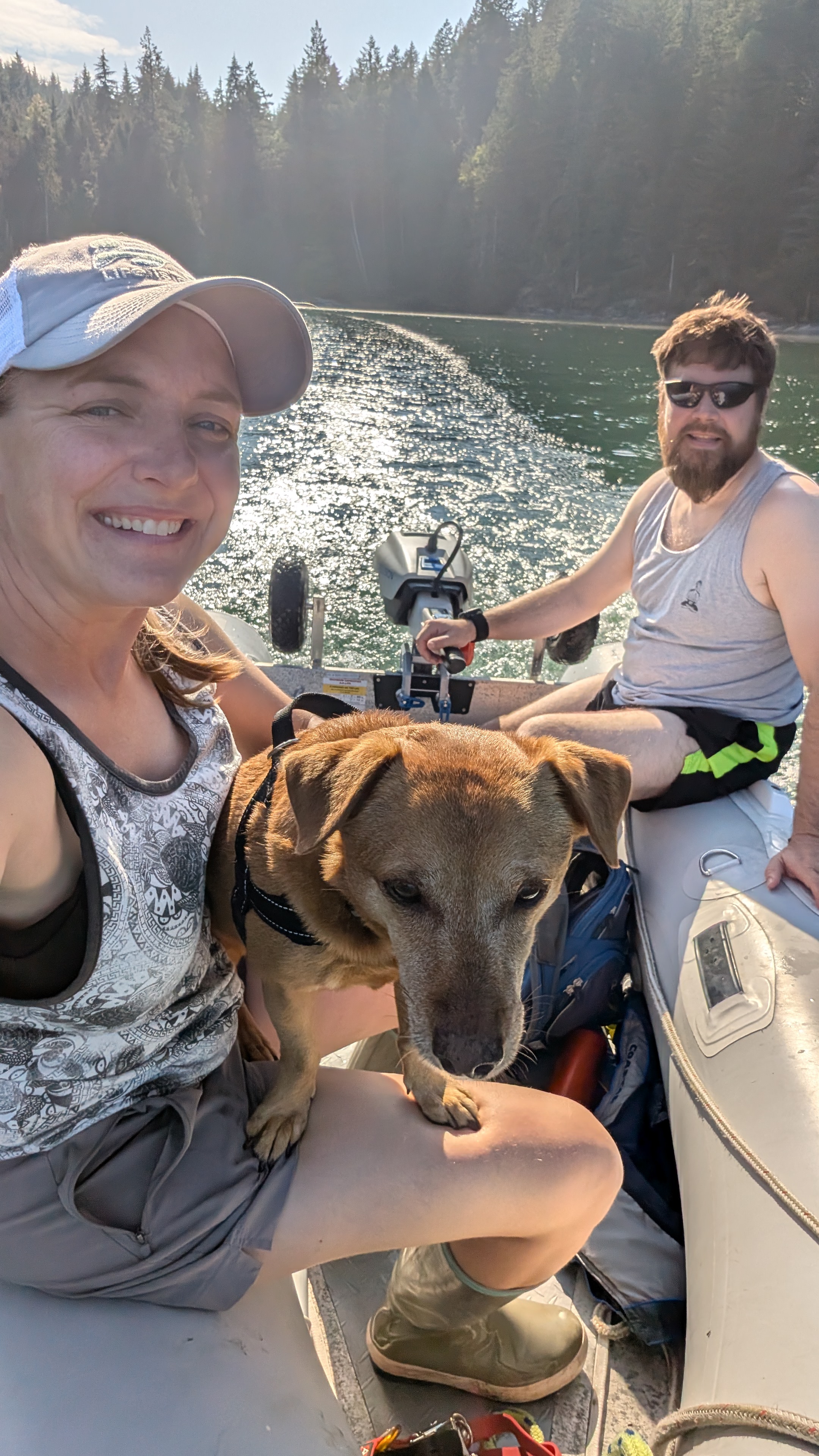 Rachel, Brian, and Maui selfie in the dinghy during golden hour at Octopus Islands