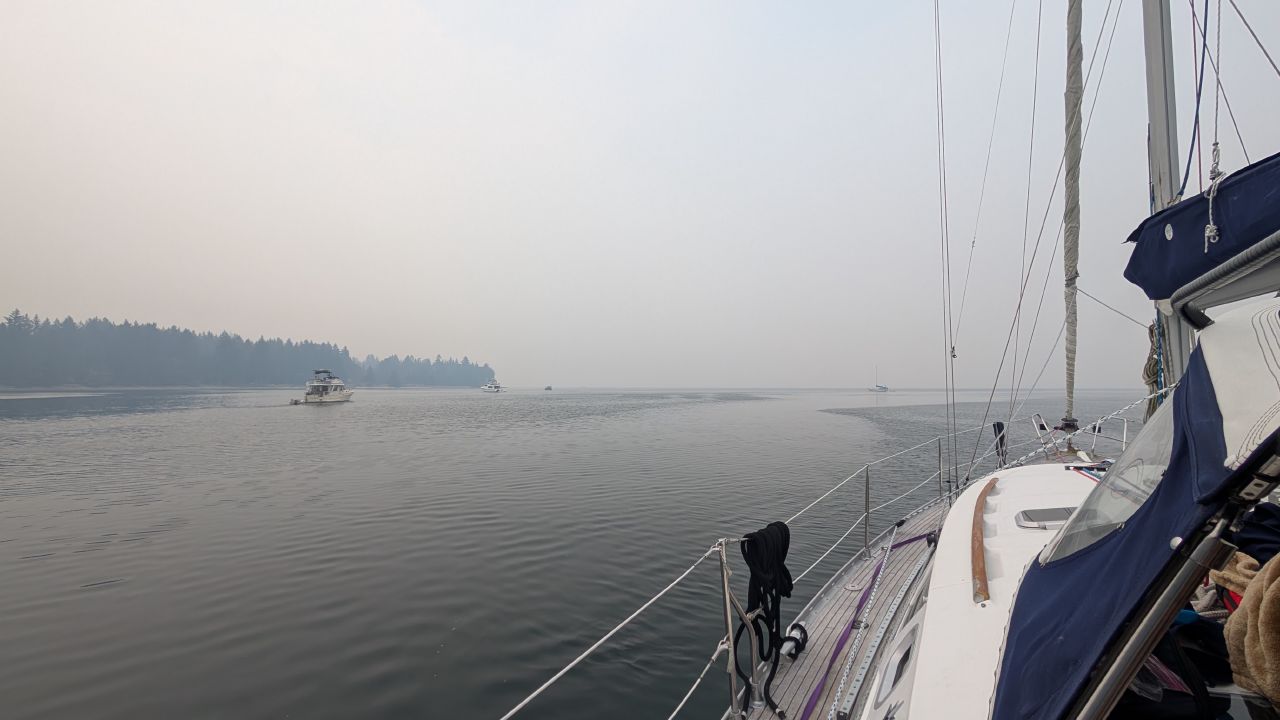 Thick wildfire smoke obscuring visibility as SV Yahara motors toward Comox with another boat in the haze