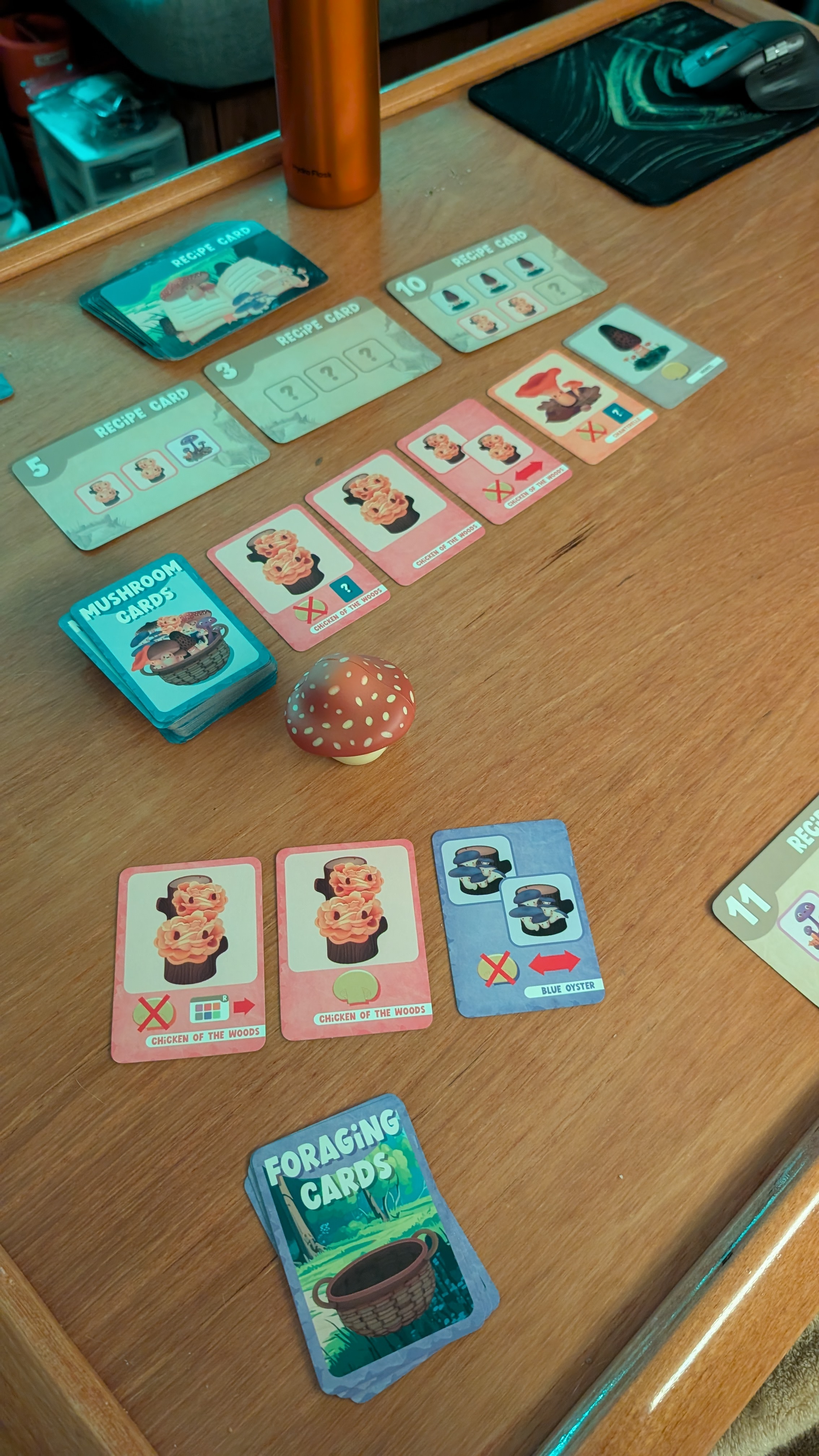 Mushroom foraging card game laid out on the boat&rsquo;s cabin table with recipe and foraging cards